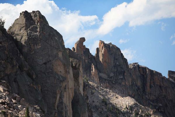 El Pima, midway on the ridge between Cirque Lake Peak and Baron Spire, "signifies that the summit resembles a great cat claw."
