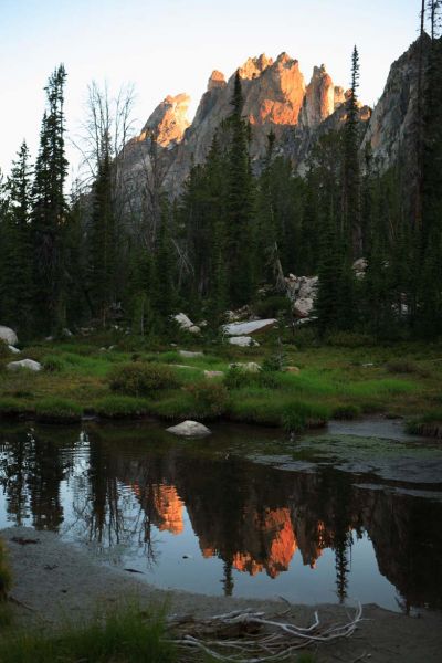 Dawn; Warbonnet Peak, and the Cirque Lake Peaks Group, reflected in stream above Feather Lakes.
