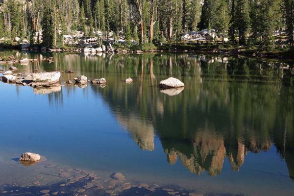 Feather Lake reflects Warbonnet and the Cirque Lake Peaks Group.
