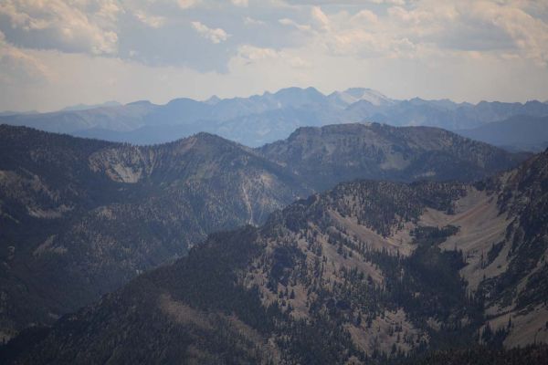 Over 90 miles east southeast of Pinyon Pine Lookout, the Lemhi Range is seen on the horizon.  The obvious drainage in the right forground points toward Bell Mountain (left) and Diamond Peak (right) on the skyline.
