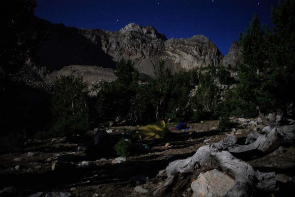 A near-full moon lights camp.
