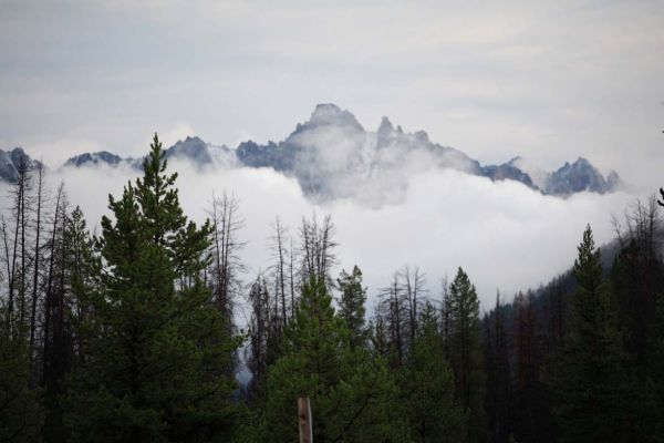 Convection fog in Redfish Lake basin warms, rising to obscure Grand Mogul.
