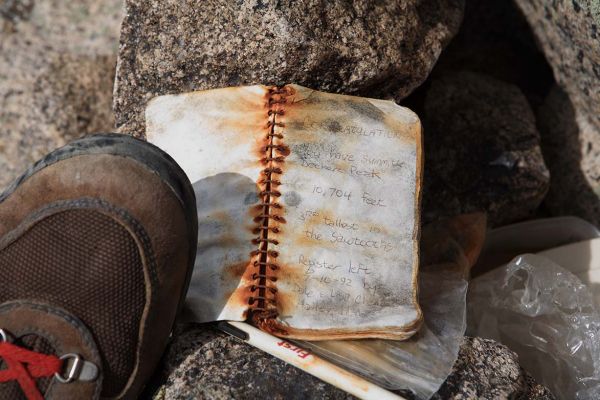 A weathered summit register dating from July 1993 congratulates those who find it.
