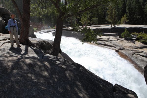 Having left our heavy packs behind in the backpacker campground, we arrive at the brink of Nevada Falls.  Entering the seemingly tranquil pools upstream of the footbridge has resulted in numerous park visitors being swept over the falls.  We opt to descend the steeper "Mist Trail", and return by the longer Muir Tail with its grand views.
