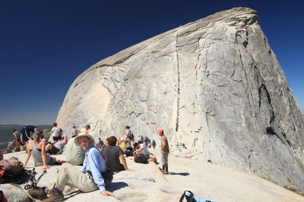 The circus arrives at Half Dome.  The Park Service does little to expedite this traffic jam, feigning a policy of non-interference in the "wilderness".  They need to be reminded, they now enforce permits to ascend this trail, and installed the cables in the first place!  The Snake Dike route 180 degrees around the dome, on the Valley side, is a much nicer climb up Half Dome.
