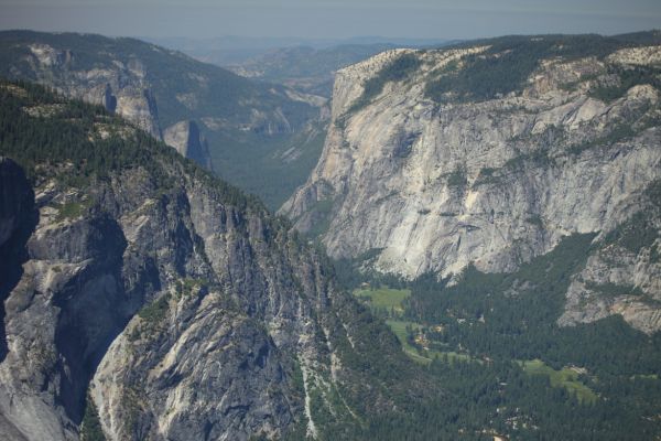 Looking west from the top of Half Dome, from the left, Glacier Point and in lower left corner, the Glacier Point apron; Sentinel Rock, and Cathedral Rocks rise above and behind; El Capitan, partilally hidden across the Valley.
