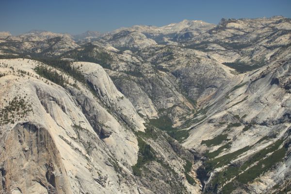 Closer; looking northeast from the top of Half Dome up Tenaya Canyon, past the domes above Tenaya Lake, to Mt. Conness, 20 miles distant.  Matterhorn Peak, on Yosemite's northern border is on the horizon, left frame.
