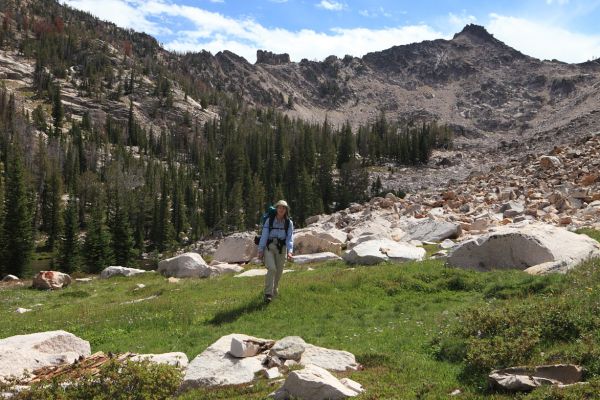 The Baron/Warbonnet Lakes saddle can be seen directly above Elisa, who is walking west toward Feather Lakes.
