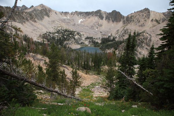 Reward Peak rises southeast of Packrat Lake on the left.  Our route exits this valley left of the peak.  A path of loose scree emanating from behind a ridge can be seen leading up and left if one looks directly below the summit of the peak almost down to the trees.
