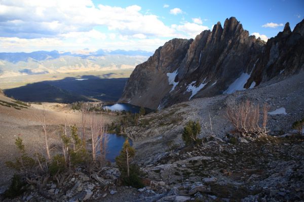 The benches get steeper below the trees in the lower left corner, leading to the upper lake.  The lower of the lakes in the foreground is the "unnamed lake".  The light still reflects on Redfish Lake at the edge of Thompson Peak's shadow advancing across the valley.  Little Redfish Lake is fully in sunlight further left.
