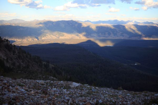 Thompson Peak's shadow reaches across the valley between Redfish and Little Redfish Lakes.  The dark meadow marking the beginning of the climber's trail leading back to Alpine Way can be seen in the lower far left, just above the boulder field.
