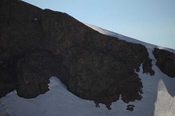 Sun shining through a cornice high on the eastern side of the crest south of Summit Lake.
