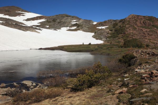 One the other side of the saddle, we passed a small lake, swollen by all the melting snow.
