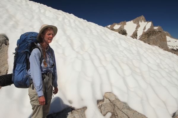 Close to the highpoint on the ridge, the professor catches her breath.  North Peak rises dramatically behind.
