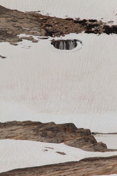 A cascading stream running under a lower section of the Conness Glacier has opened a sinkhole.
