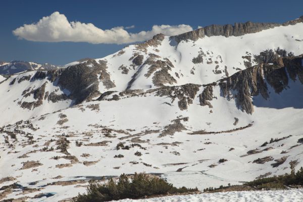 A wider view looking south of the east ridge of Mount Conness on the skyline, and the east ridge of North Peak in the middle ground.  Frozen Cascade Lake is now below us in the foreground.
