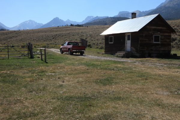 The saddle in the distance on left above fence is Leatherman Pass.  Borah Peak is the pointed summit furthest back above cab of truck.
