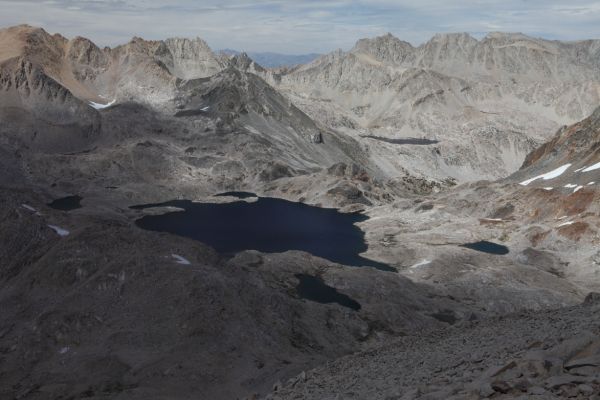 Lake Helen northeast from the summit of Mt. Solomons.  Echo Col is directly above the lake at the lowpoint of the ridge in front of the most distant dark ridge on the horizon (the White Mountains across the Owens Valley).  Wallace Col, almost 560' higher, is the low point on the red-hued ridge above the snow patch in the upper left of the photo.
