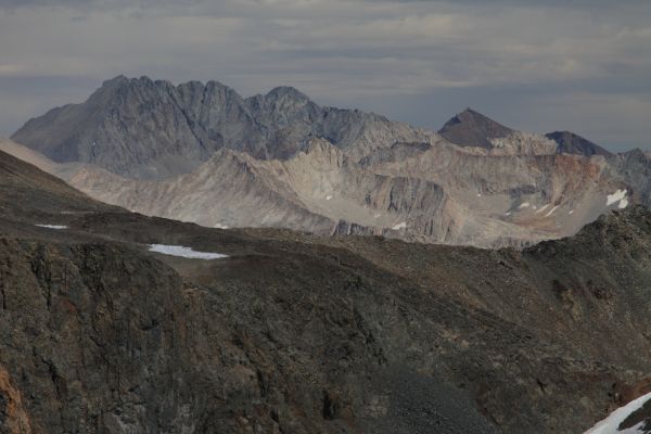 On the distant Sierra Crest to the east, Middle Palisade (left), and the pyramidal shaped The Thumb beyond the Black Divide, from the summit of Mt. Solomons.
