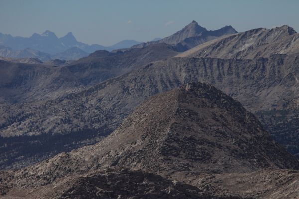 50 miles to the northwest, Mt. Ritter, on the left with its distinctive snowband, and Matterhorn-shaped Banner Peak to the right, dominate the skyline for miles.
