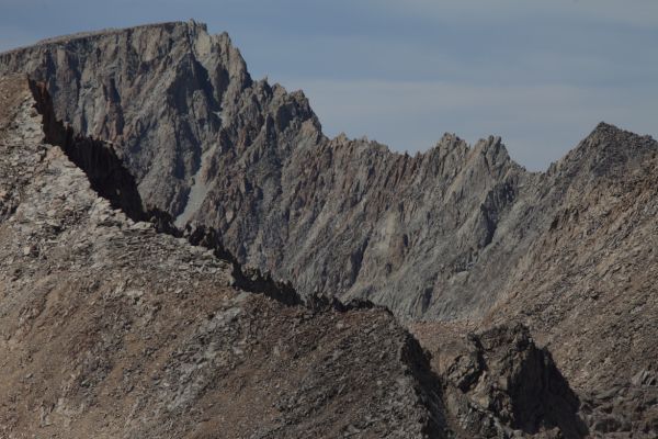 Mt. Darwin on the Sierra Crest from the summit of Mt. Solomons.  Mt. Darwin stands at the head of Darwin Canyon, about 1.66 miles south of Lamarck Col.  The ridge in the foreground is the southeast ridge of Mt. Warlow (to the left, not visible).  Warlow can be ascended via this ridge (class 1) from Muir Pass.  The telephoto lens makes this ridge appear much closer to Mt. Darwin than it is.  Darwin is over 3 miles beyond the ridge to the north.  I summited Darwin more years ago than I would care to admit!
