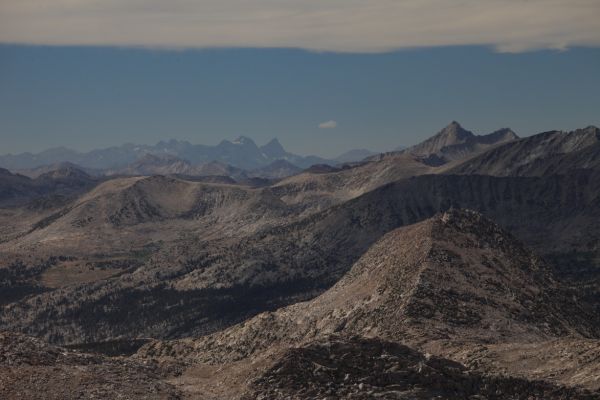 50 miles to the northwest, Mt. Ritter, on the left with its distinctive snowband, and Matterhorn-shaped Banner Peak to the right, dominate the skyline for miles.
