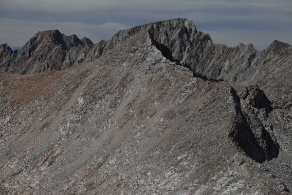 The ridge in the right foreground is the southeast ridge of Mt. Warlow, and can be ascended to Warlow's summit (class 1) from Muir Pass.  Over 3 miles to the north directly behind Warlow (center) is Mt. Darwin on the Sierra Crest; from the summit of Mt. Solomons.
