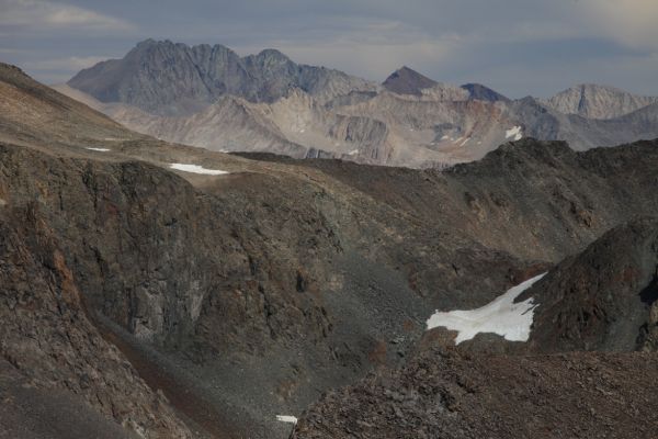 On the distant Sierra Crest to the east, Middle Palisade (left) and the pyramidal shaped The Thumb beyond the Black Divide, from the summit of Mt. Solomons.
