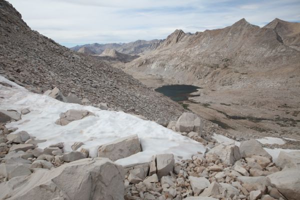 Lake McDermand east of Wanda Lake in Evolution Basin.  Some snowfields will give us a break from boulder hopping on our descent from the saddle below the west ridge of Mt. Solomons.
