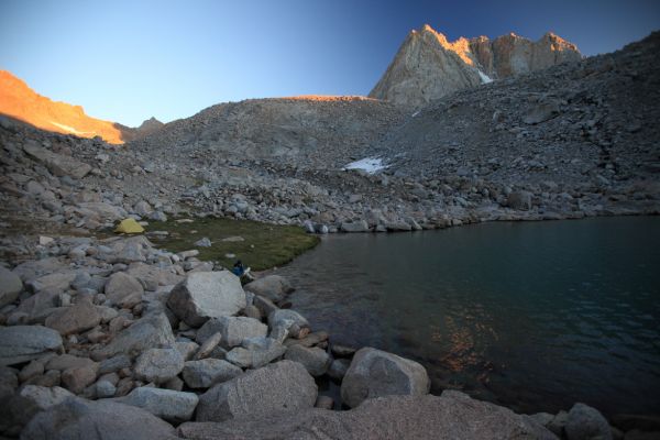 Mt. Mendel in alpenglow above our small patch of meadow, east side of the highest lake in Darwin Canyon.  The professor purifies water for dinner preparation.
