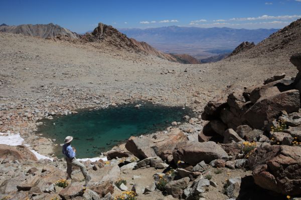 To the northeast past a high tarn, Bishop in the Owens Valley.  The White Mountains in the distance.
