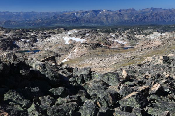 Route 212, the Beartooh Pass Highway, traverses the valley northwest to southeast in front of the peaks on the horizon.  The area is in the vicinity of the intersection of 212 and Chief Joseph Highway.
