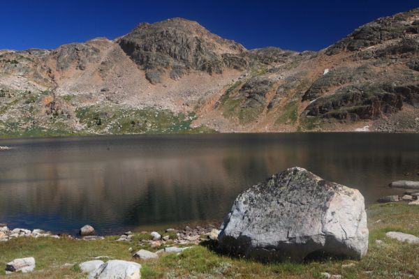 Looking east across Crystal Lake reveals the steep descent route (directly above the highest point of the foreground boulder).
