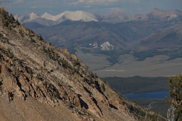 Yellow Belly Lake, Stanley Valley, and the White Clouds in the distance from the notch north of Sand Mountain Pass.
