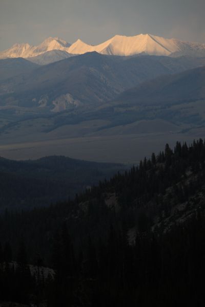 The sunlit White Clouds stand out beyond the storm shrouded Sawtooth Mountains and Valley.  WCP-9  is the white limestone pyramid, with D. O. Lee Peak to the right (south).
