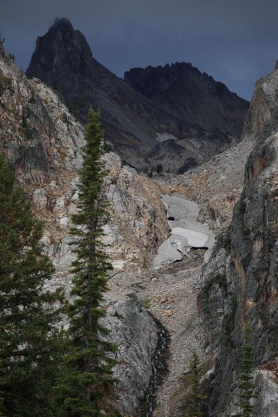 The remaining consolidated snow in the couloir draining into the south end of Goat Lake offers a fast route to the upper lake basin we had hoped to reach before dark.  Thompson Peak, our objective for the following day, appears to be making its own weather.
