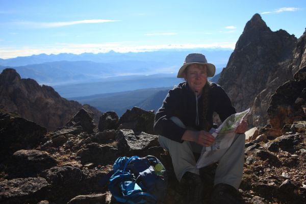 Just before 10 am, the professor checks the route description on the Thompson/Mickeys Spire Saddle.  Castle Peak, 11,815', the highest peak in the White Cloud Mountains can be seen on the skyline about 1/3 from the left edge of photo.
