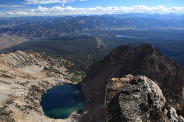 The "unnamed lake", and the use trail to it intersects Alpine Way trail about where the ridge leading down from the left frame of photo meets the trees.  5 mile long Redfish Lake lies southwest of Little Redfish Lake.
