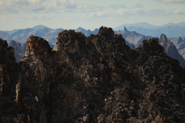 The distinctive profile of North Raker (Red Finger), south from the summit of Thompson Peak.  The only route up is class 6 (direct aid).
