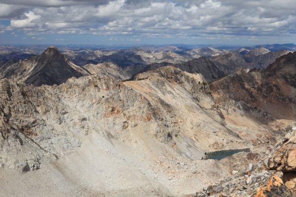 Orange topped Mt. Regan in shadow on the left, northwest from the Thompson/Mickeys Spire Saddle.  The higher, western-most lake in the upper lake basin leading to the saddle is in the lower right of photo.
