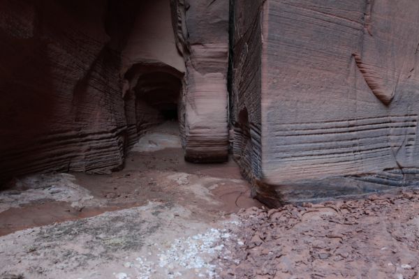 This tunnel appears to lead deep into the canyon wall, but in realitiy is only a few feet long.  The striations seemed as if carved precisely by a machine.  At the base of the wall on the right is some of the dried, curled top layer of mud, that resembles shaved chocolate.
