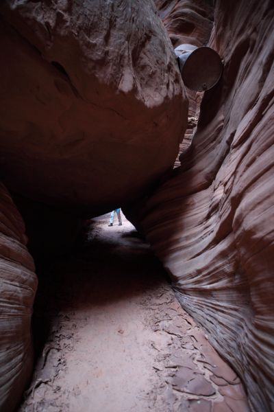 Just downstream there is another narrow spot with a low ceiling.  A rusting steel barrel is jammed in the crack above.
