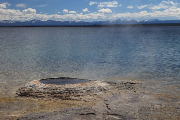 Fishing Cone Geyser, Yellowstone Lake and Absaroka Range beyond; West Thumb Geyser Basin.
