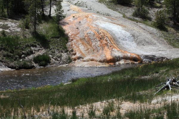 Runoff from hydrothermal features seeps into the Firehole River northeast of Old Faithful; Upper Geyser Basin.
