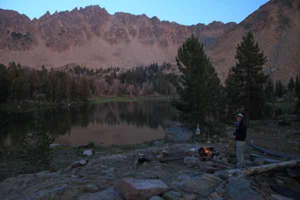 Camp at the larger of the Born Lakes at 9555'.  Readying the coals for cooking trout.  The route to Four Lakes Basin ascends the slope on the opposite side of the ridge above the lake (above and behind the Professor).
