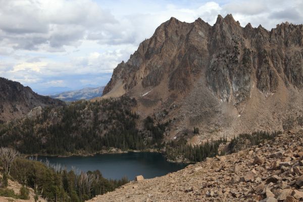 Descending northeast from Four Lakes Basin, Merriam Peak rises above Quiet Lake to the east.
