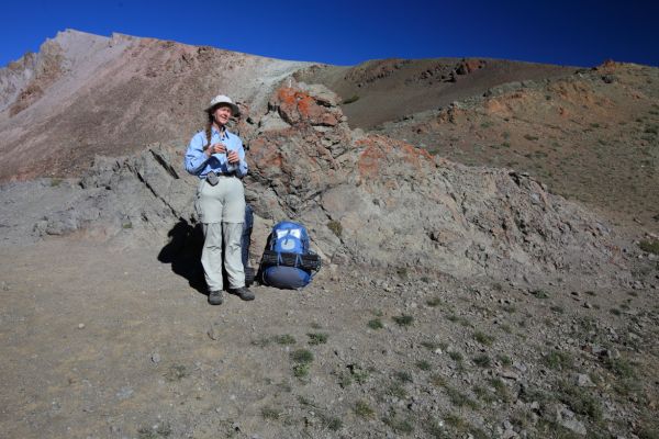 The Professor has a snack while taking in the view from the 10,000' pass that leads to Chamberlain Basin.
