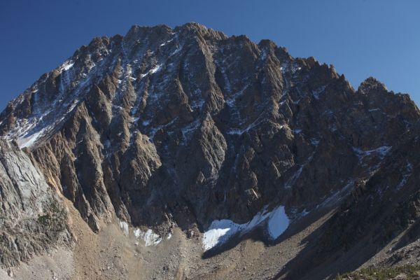 Castle peak, still dusted with snow from an early storm that exited the day before Labor Day, from the wide saddle between Born Lakes and Four Lakes Basin.
