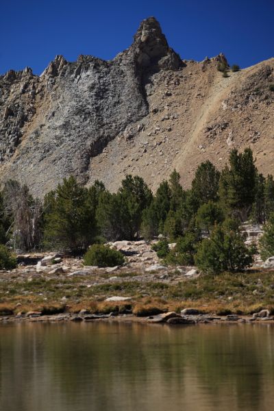 As viewed from the east, a "large gray pinnacle on a fractured ridge guards a notch called the Devil's Staircase," as Margaret Fuller states in her description of the same, viewed from the west above the highest of the Born Lakes.
