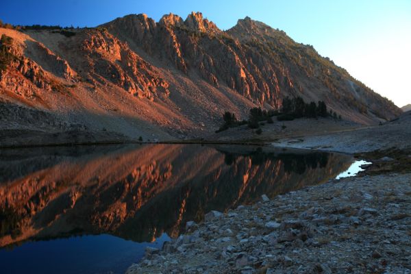 As the sky brightens, the reflections of the peaks in the lakes become more intense.
